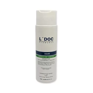 Frasco de 200 ml del champú L’DOC Hair Complete: empaque blanco elegante, imagen clara del logo y etiqueta azul-verde indicando cuidado capilar.